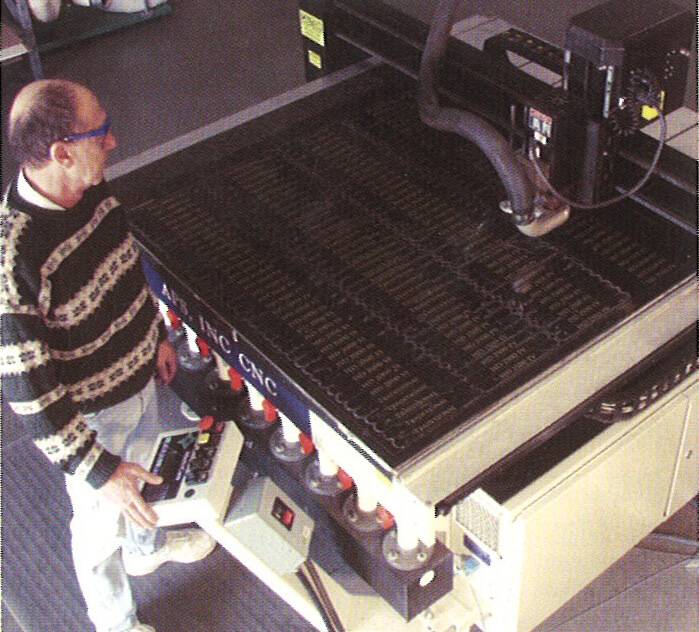 APS owner and founder, Dave Fertig, operates machinery to create personalized signage.