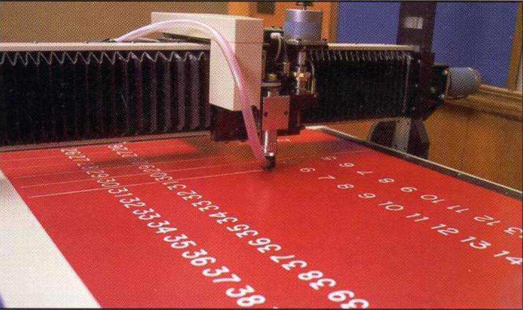 APS engraves numbers onto a vinyl board.