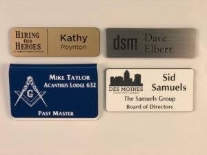 Different styles of engraved plastic name badges.