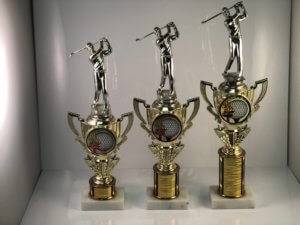 Three sizes of trophies with a golfer on the top.
